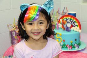 Young Girl Smiling in Front of Her Birthday Cake at The HUB Recreation Center in Marion Illinois
