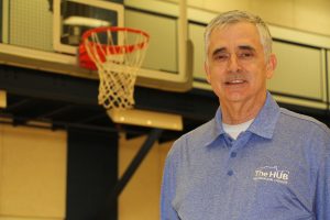 Ray Cagle in front of a basketball hoop at The HUB Recreation Center