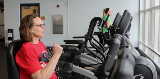 Woman on indoor cycle bike at fitness center