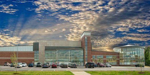 picture of outside of The HUB with clouds above and green grass below